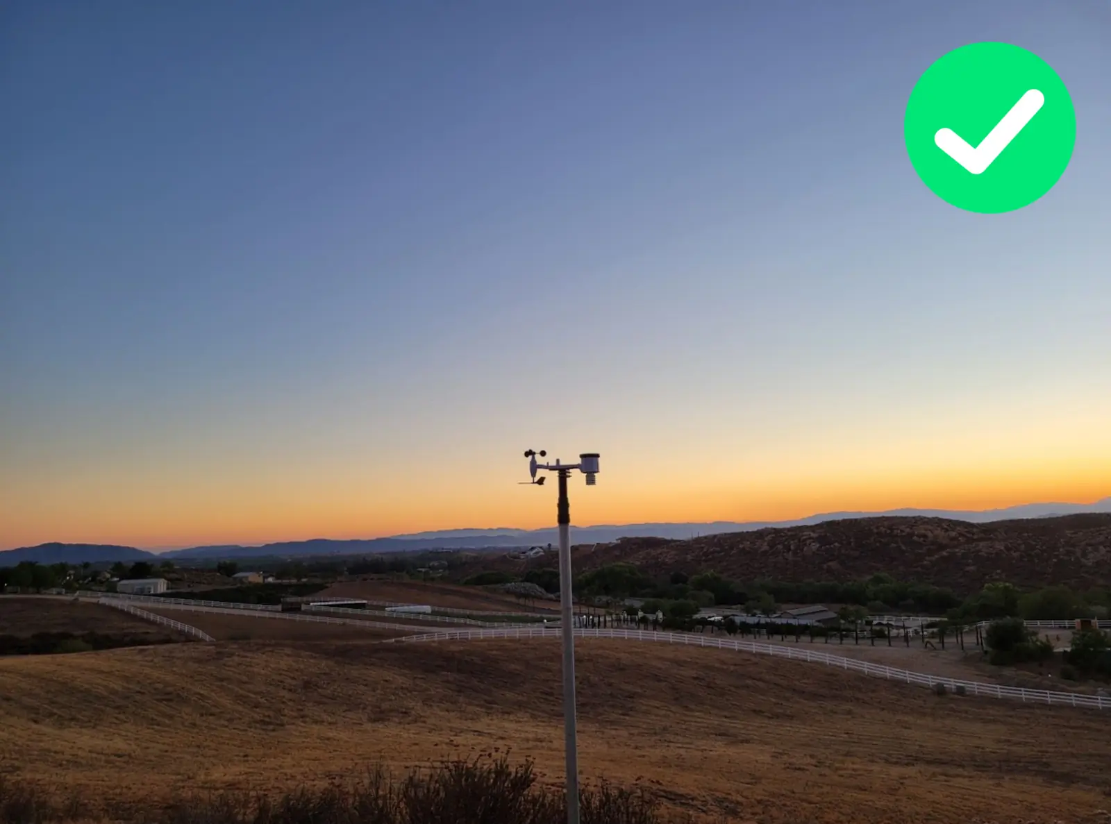 WeatherXM station on a 2.5 metre mast in an open area with a clear horizon